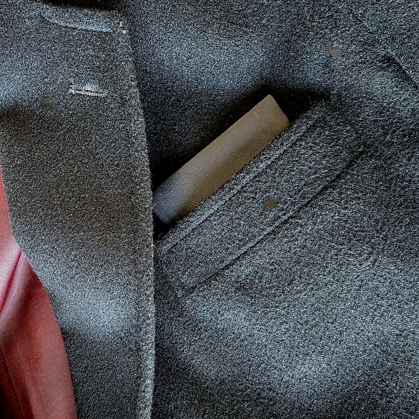 Close-up of Lux Tenebrae leather pocket square inserted in suit jacket pocket