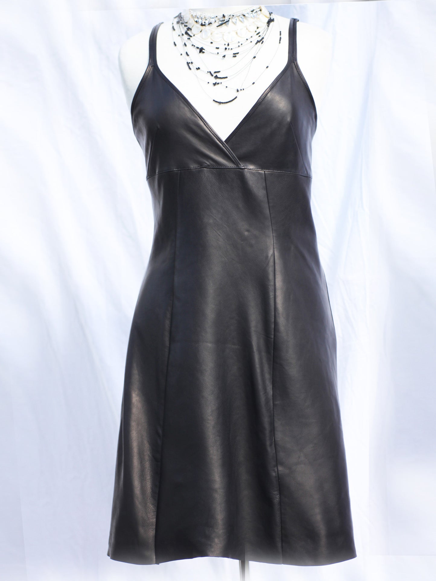 Black washable leather slip dress with adjustable straps, size UK 10, A-line leather slip dress in black—knee-length raw hem on clearance