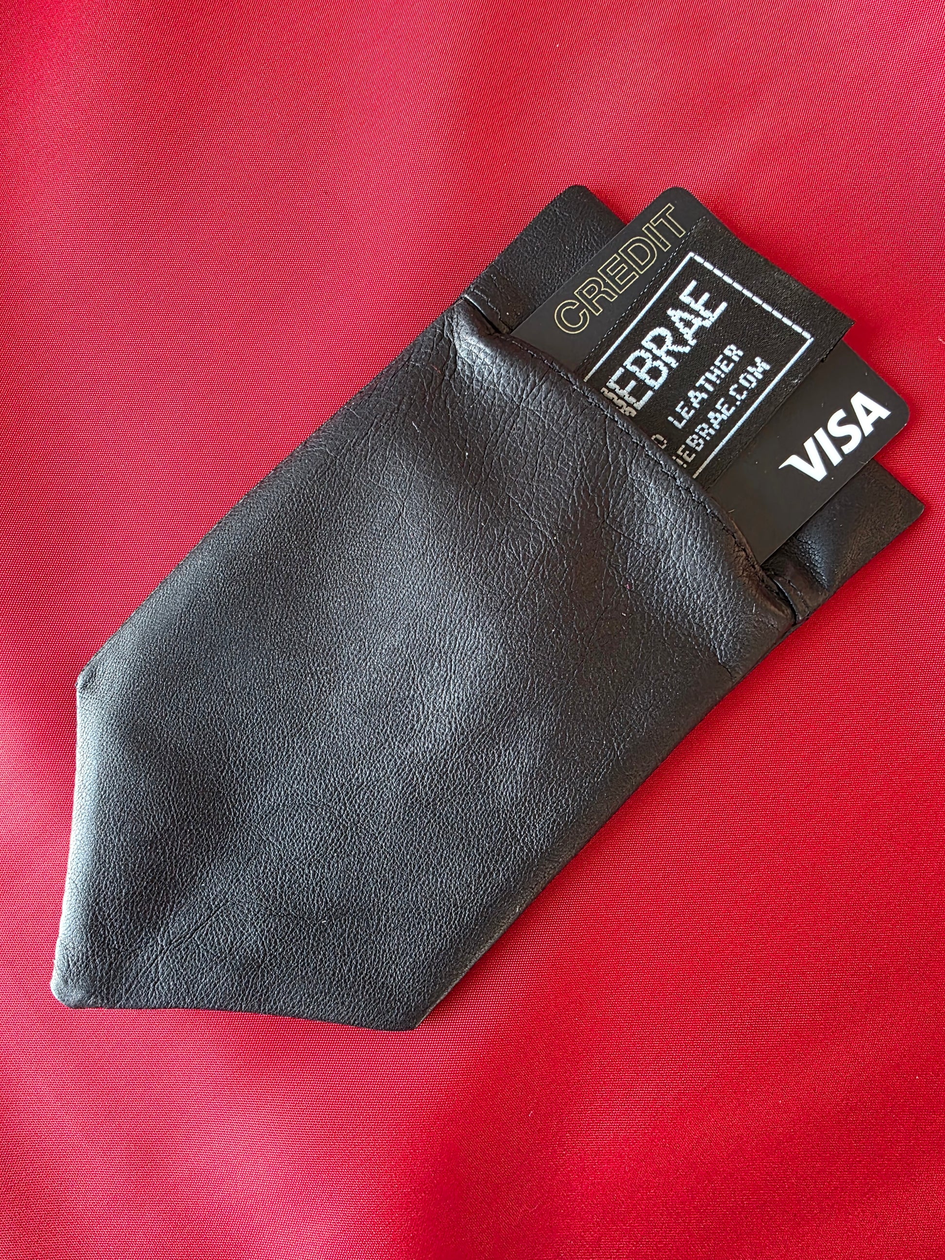 Lux Tenebrae black washable glove leather pocket square laid flat
with cards and cash