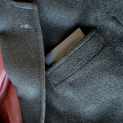 Close-up of Lux Tenebrae leather pocket square inserted in suit jacket pocket

